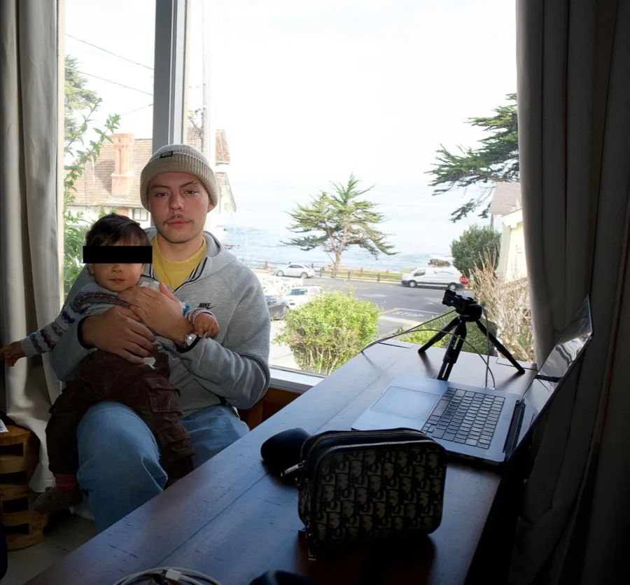 AJ at his laptop with his son, from his Instagram photo